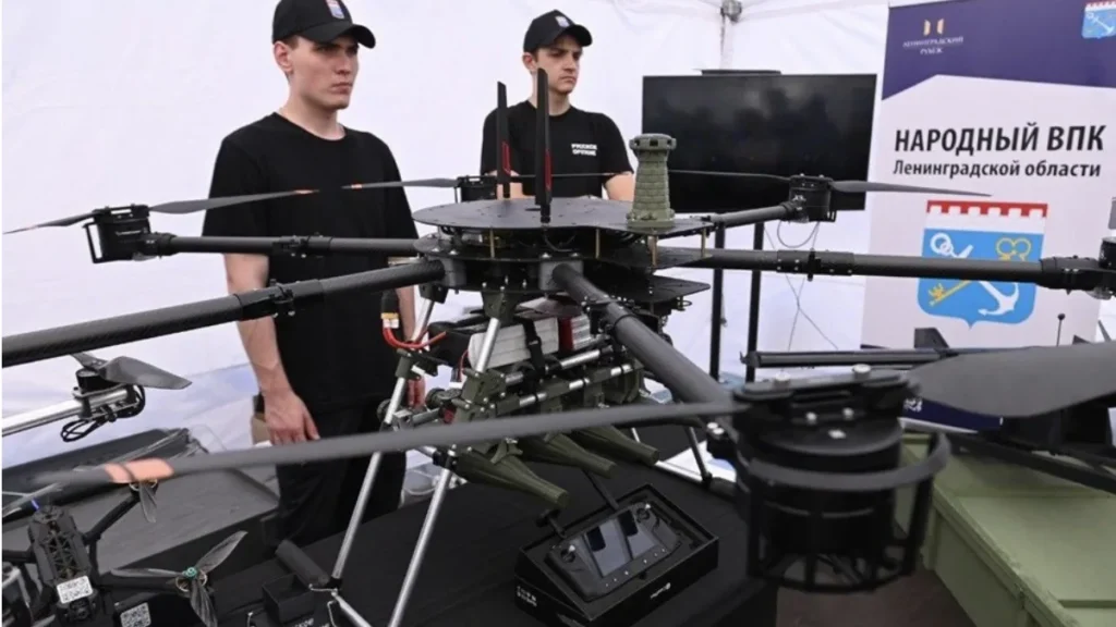 Presentation of two new UAVs in Leningrad Region, two people with the drones on the stand, booth